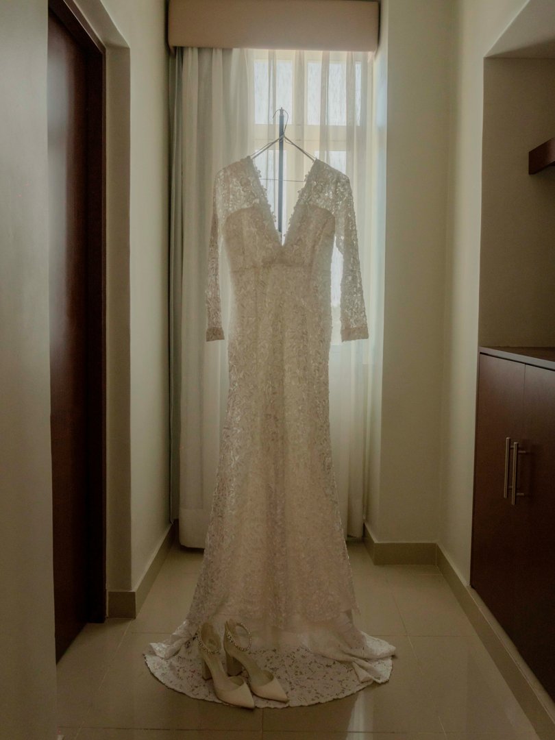 Wedding gown hanging in front of a window | Source: Unsplash