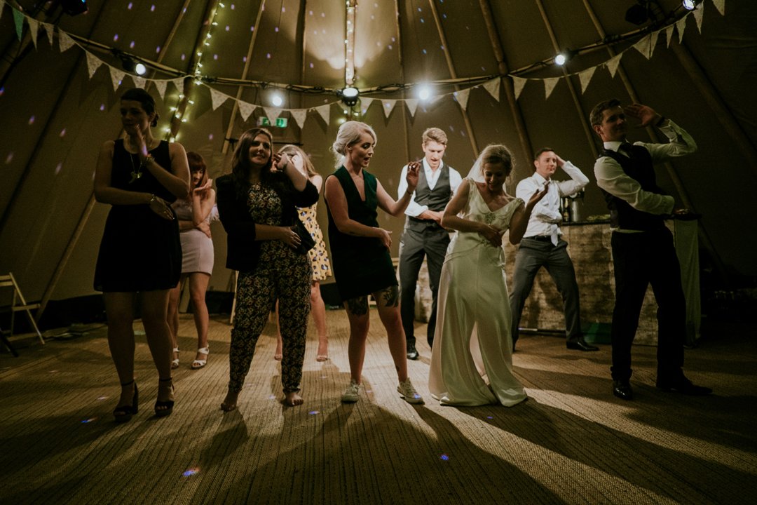 Newlyweds with guests at a wedding reception | Source: Pexels