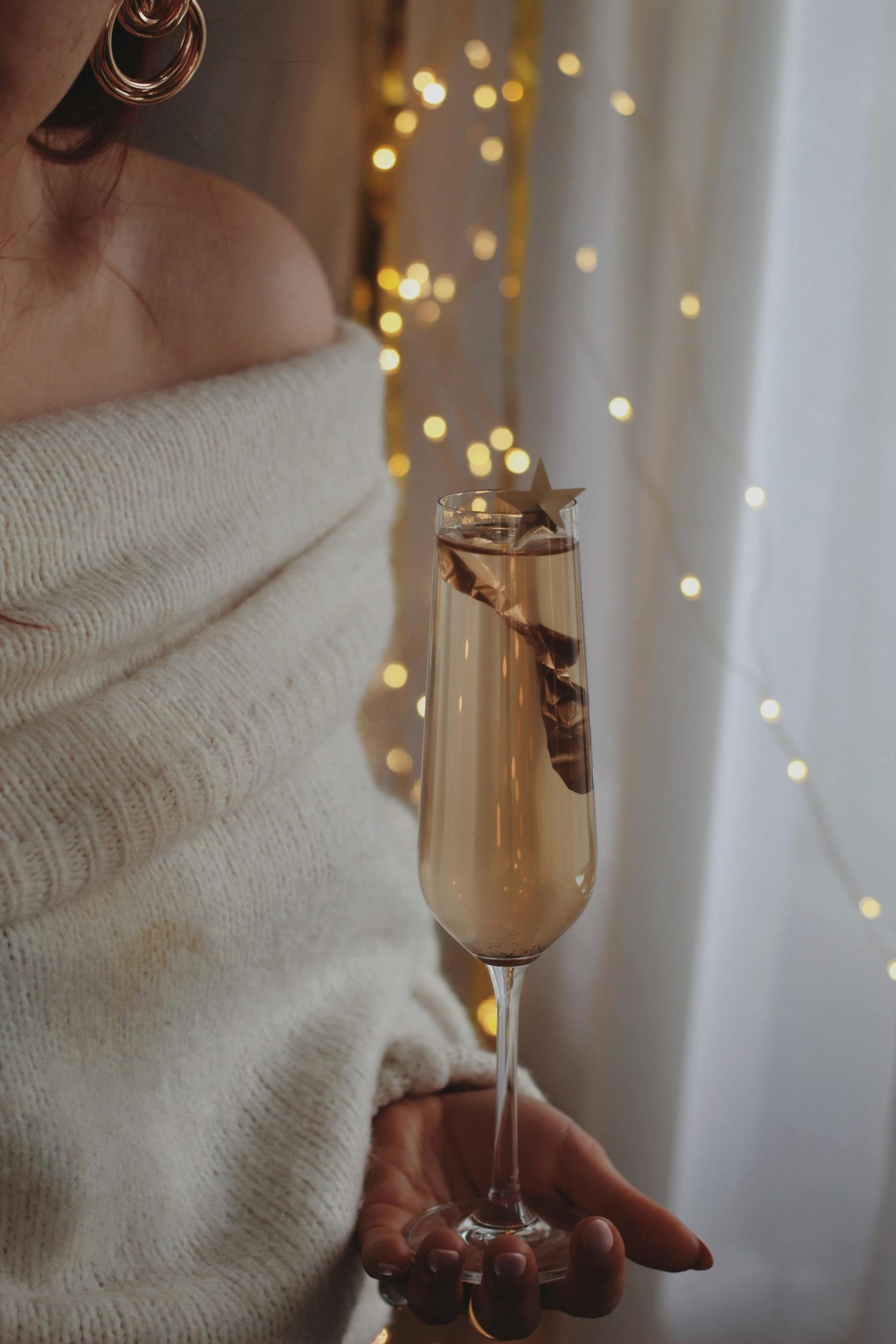 A woman holding a glass of champagne | Source: Pexels