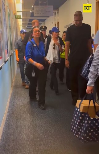 Prince Harry and Meghan Markle walking through Dodger Stadium, surrounded by security personnel, posted on October 29, 2025. | Source: Instagram/entertainmenttonight
