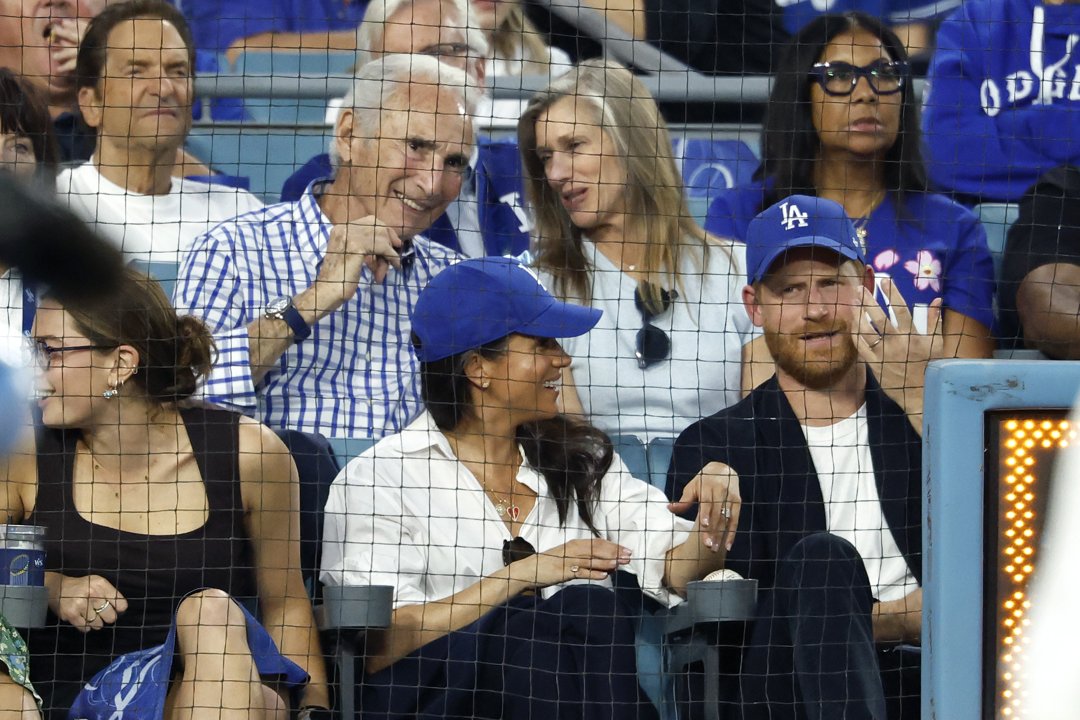 Prince Harry and Meghan Markle react during the sports event at Dodger Stadium. | Source: Getty Images