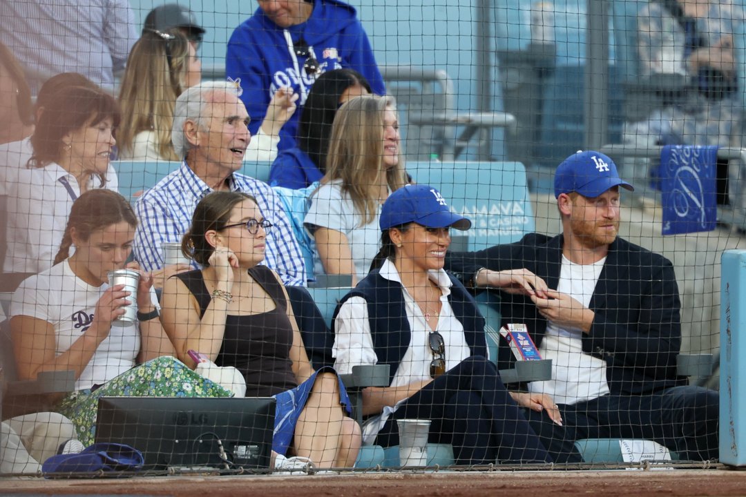 Prince Harry and Meghan Markle sit in front of Sandy Koufax as they watch Game four of the World Series between the Los Angeles Dodgers and the Toronto Blue Jays. | Source: Getty Images