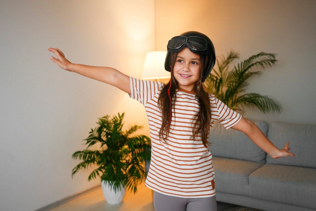 A happy young girl in a room | Source: Freepik