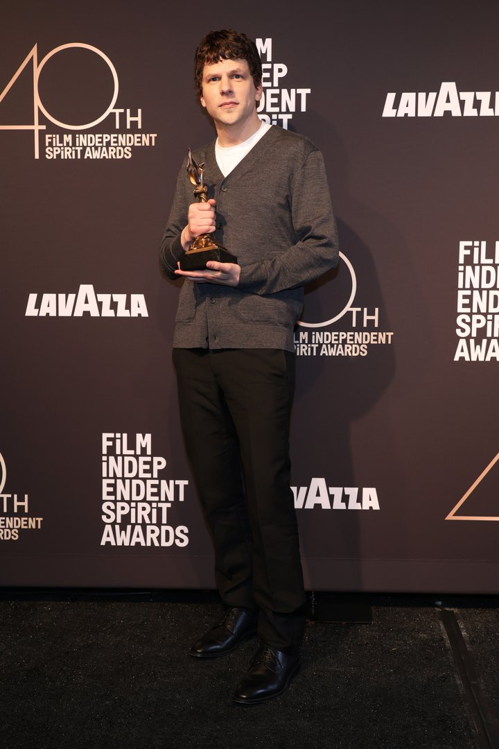 Jesse Eisenberg posing with his Best Screenplay award for 