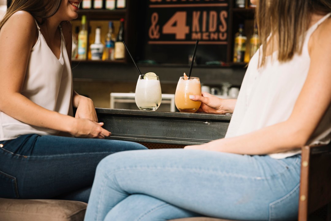 Two women chatting in a restaurant | Source: Freepik