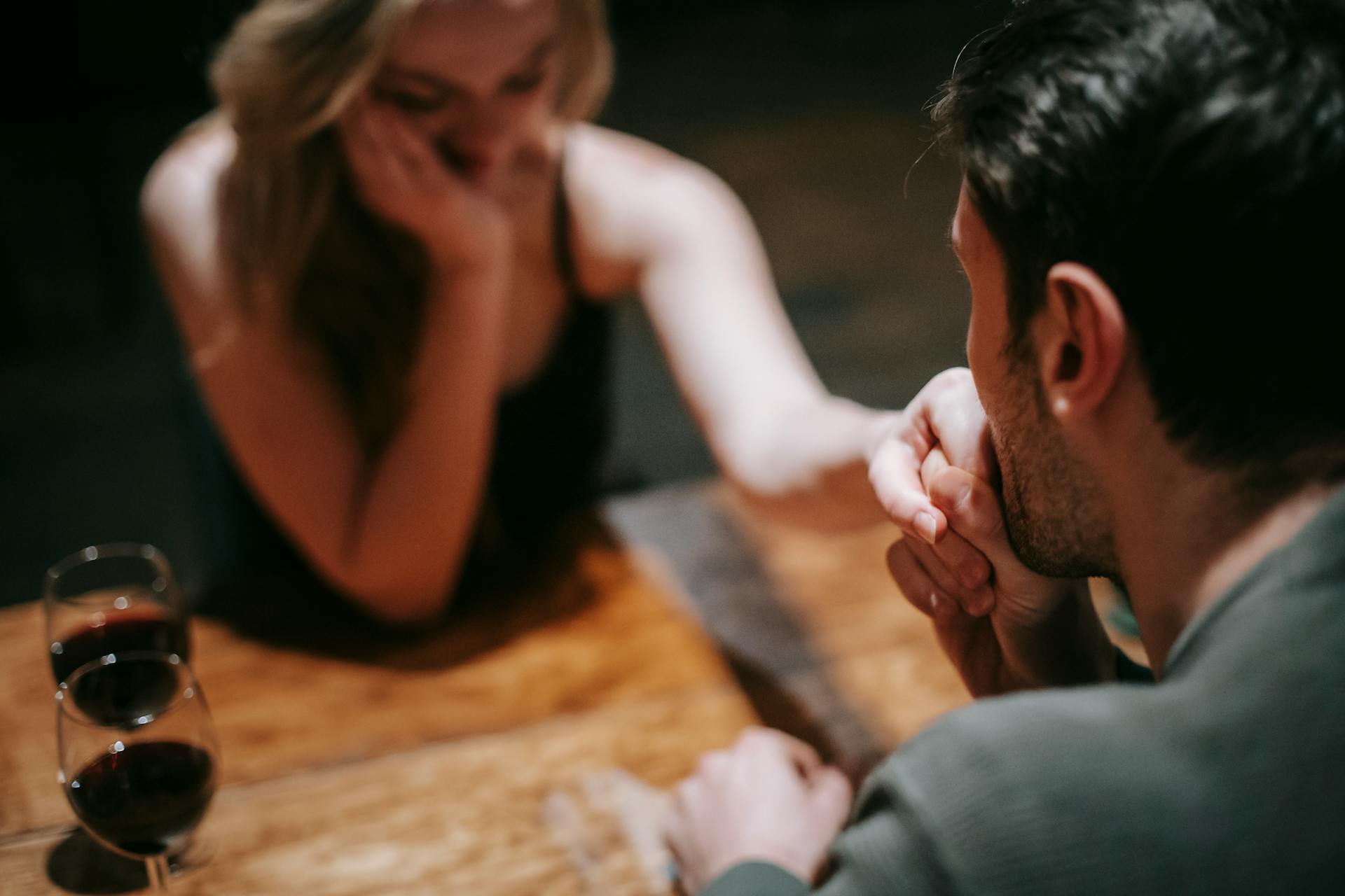 A man kissing a woman's hand in a restaurant | Source: Pexels