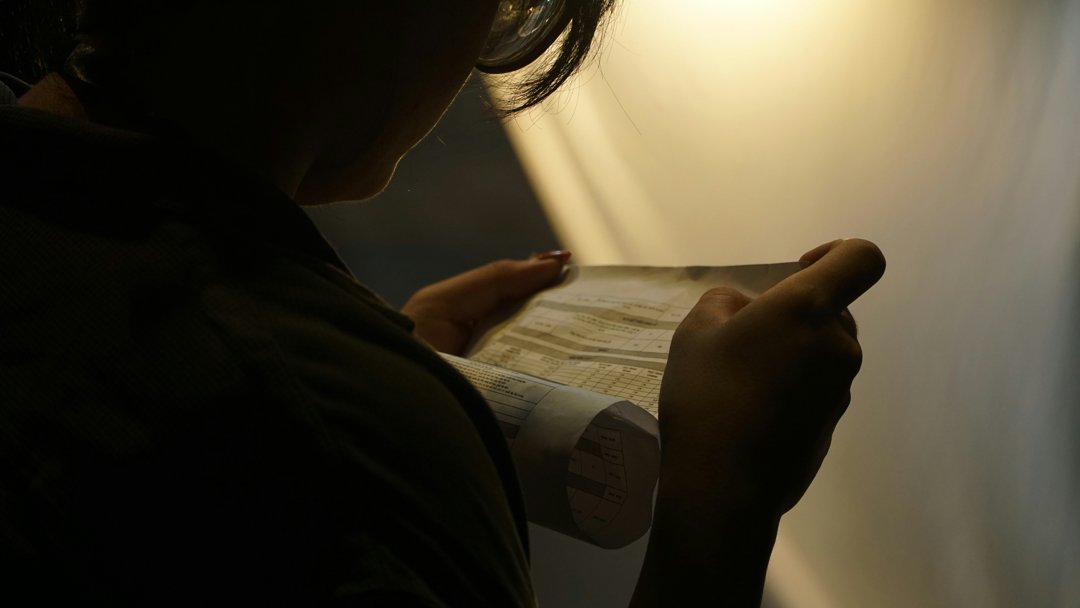 A woman scrutinizing a document | Source: Unsplash