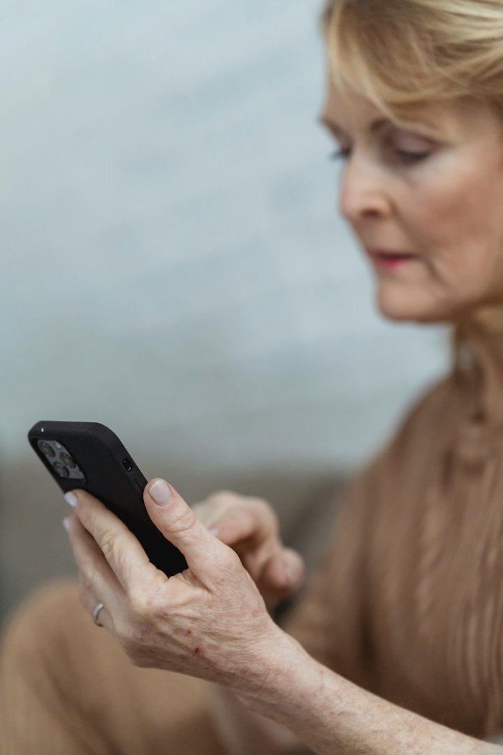 A woman looking at her phone | Source: Pexels