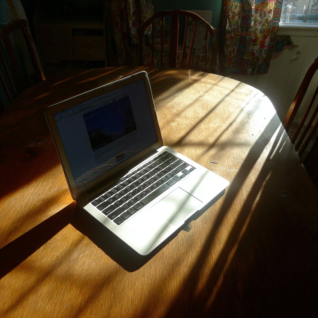 An open laptop on a table | Source: Midjourney