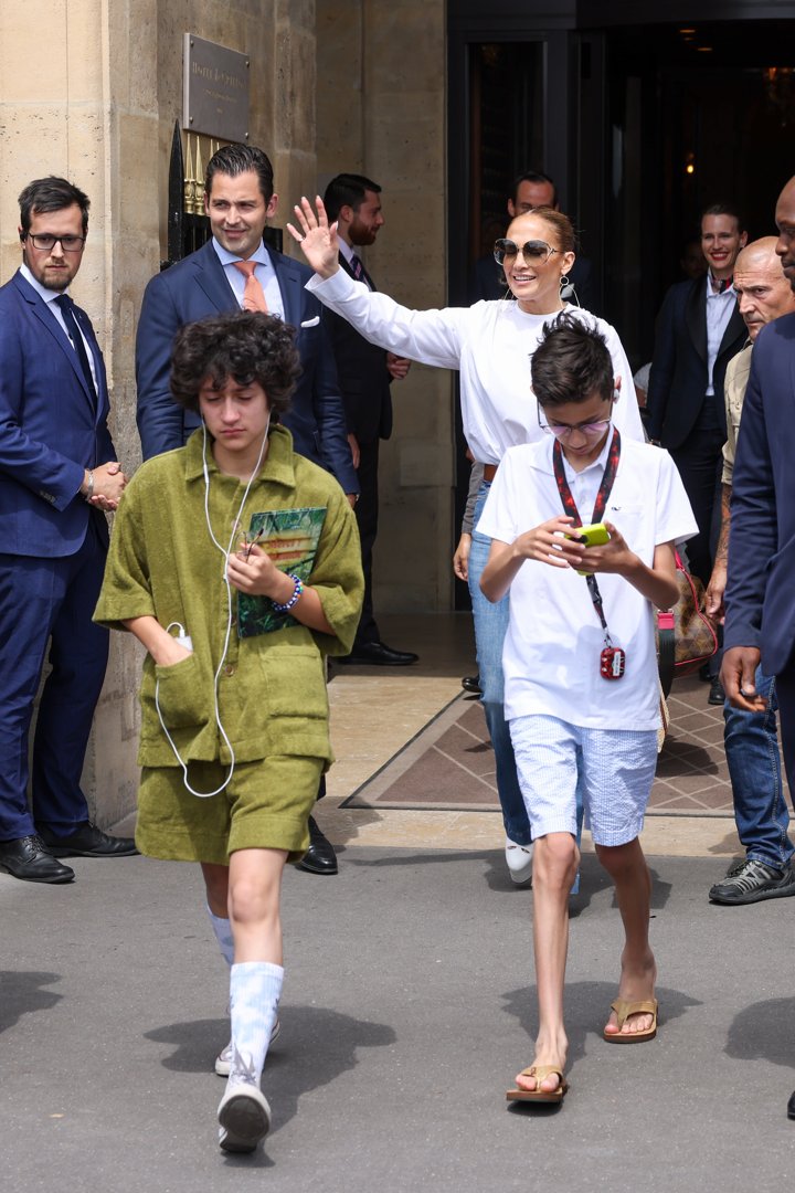 Jennifer Lopez, Emme, and Max are spotted leaving the Crillon Hotel in Paris, France. At 15, the twins exude independence, walking ahead of their mom and focused on their devices, seemingly unfazed by the paparazzi around them.