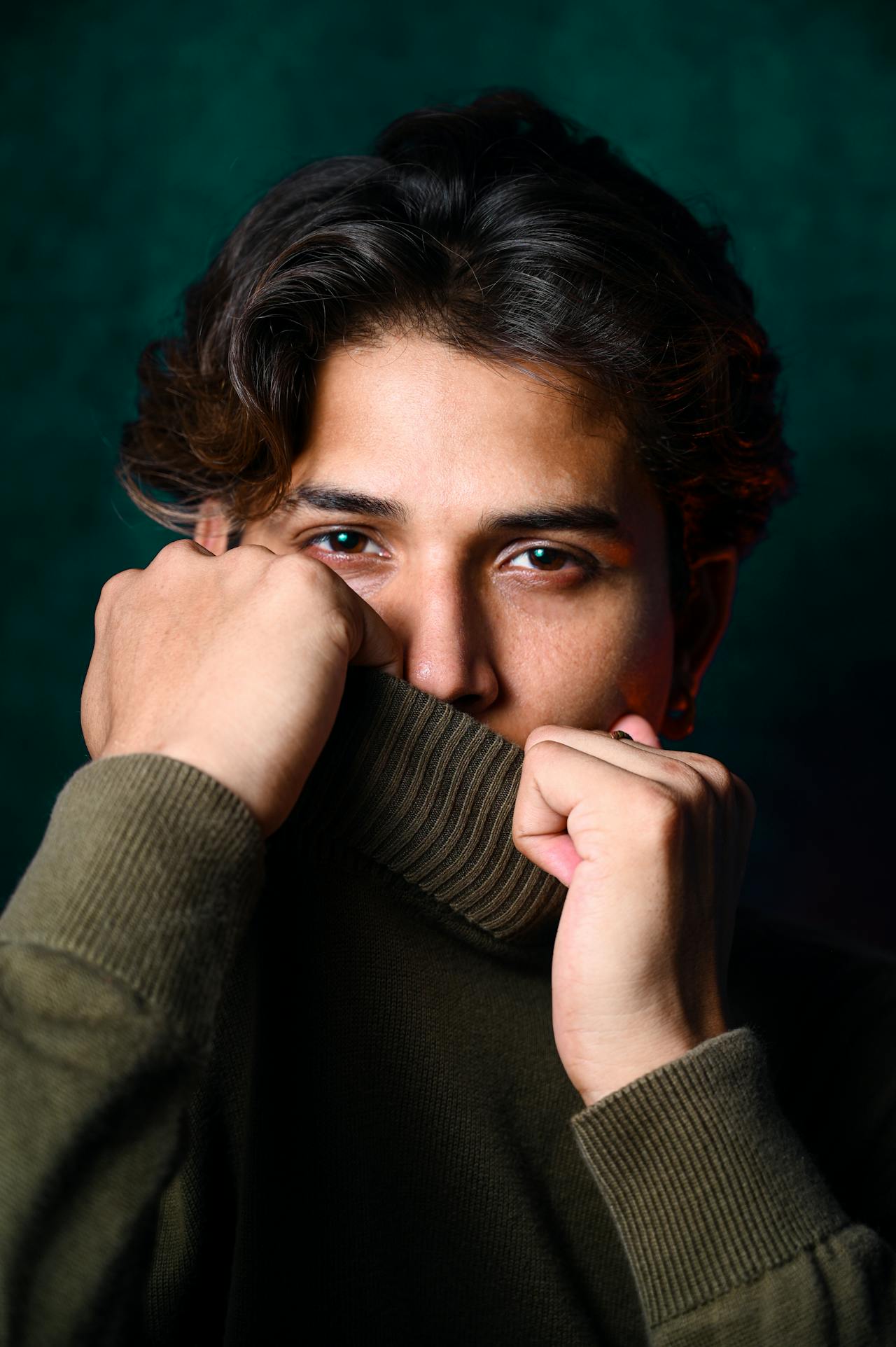 A young man in a green sweater | Source: Pexels
