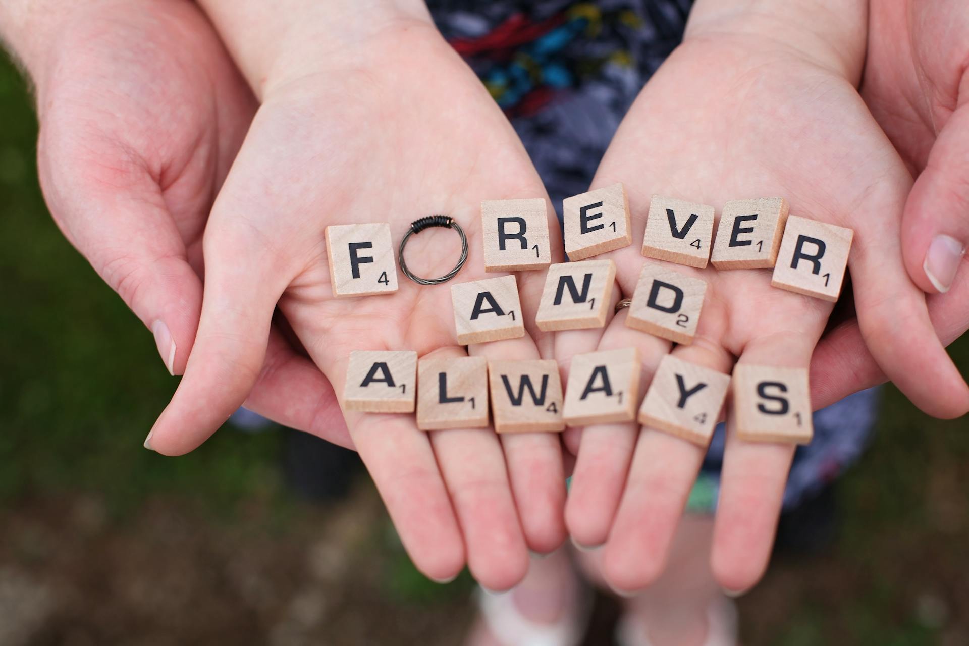Two hands holding letter blocks | Source: Pexels
