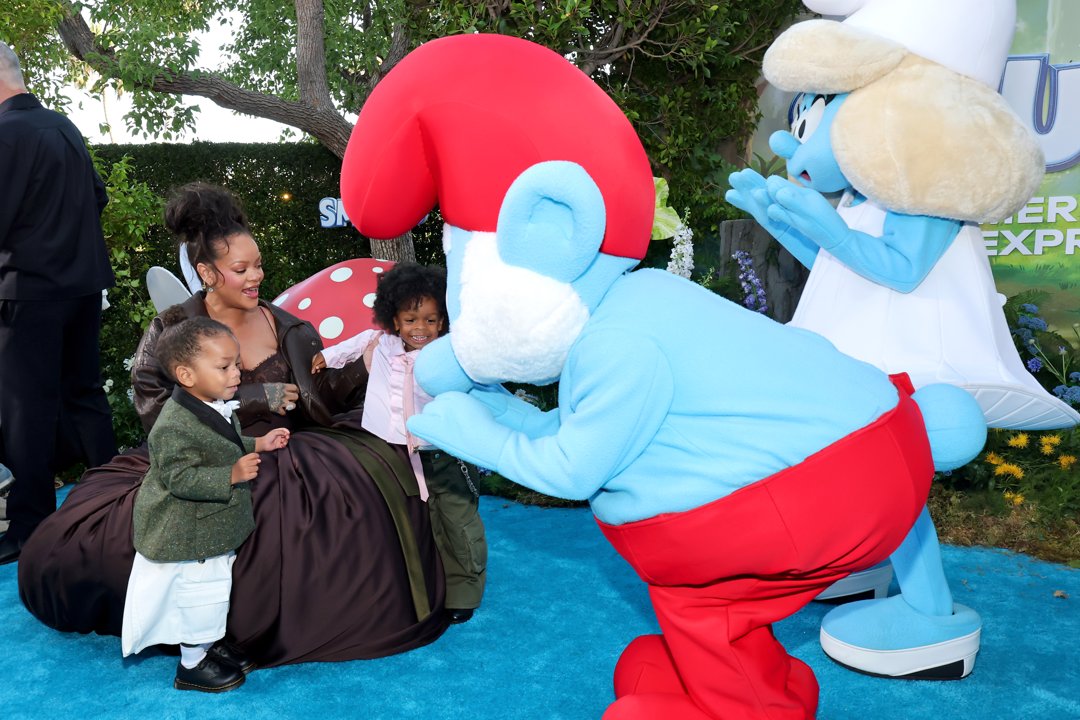 Rihanna and her sons Riot Rose Mayers and RZA Athelston Mayers interacting with costumed Smurf characters. | Source: Getty Images