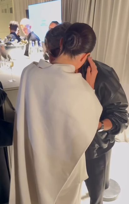 Meghan Markle whispering into designer Pierpaolo Piccioli's ear at Paris Fashion Week on October 4, 2025 | Source: Instagram/wwd