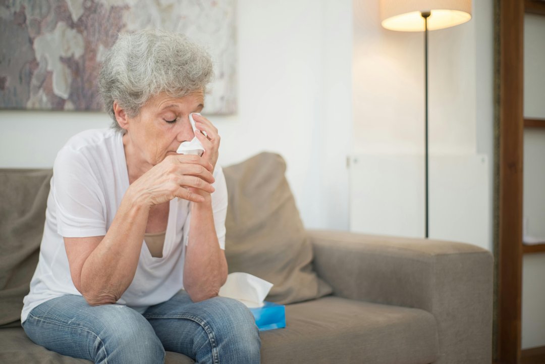 A woman wiping away tears | Source: Pexels