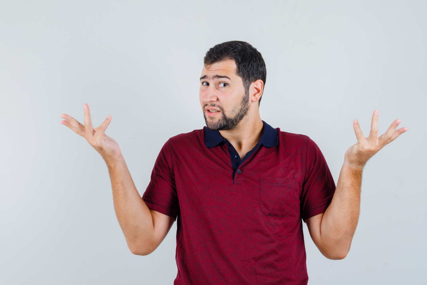An annoyed man shrugging | Source: Freepik
