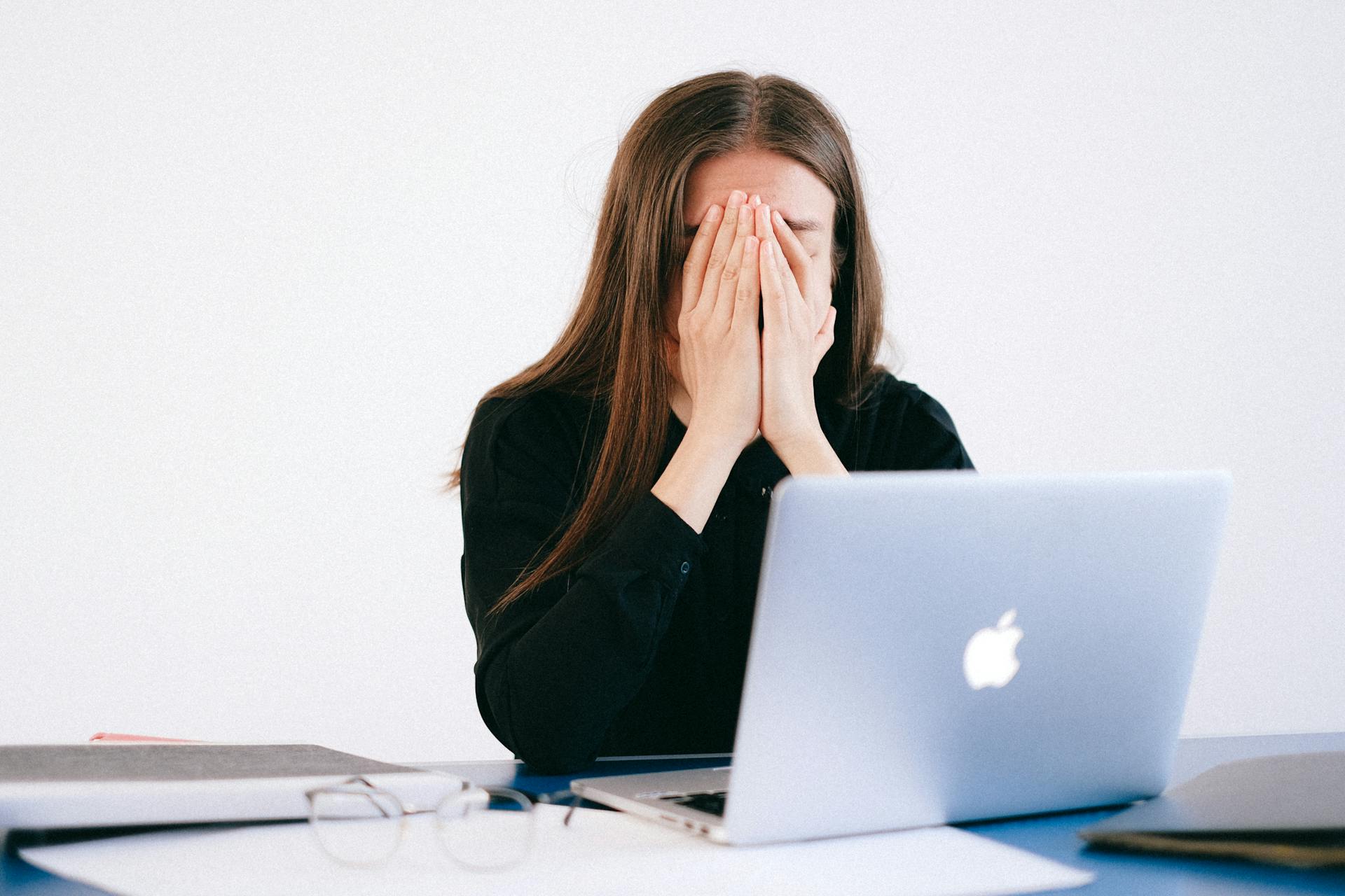 A stressed woman in her office | Source: Unsplash