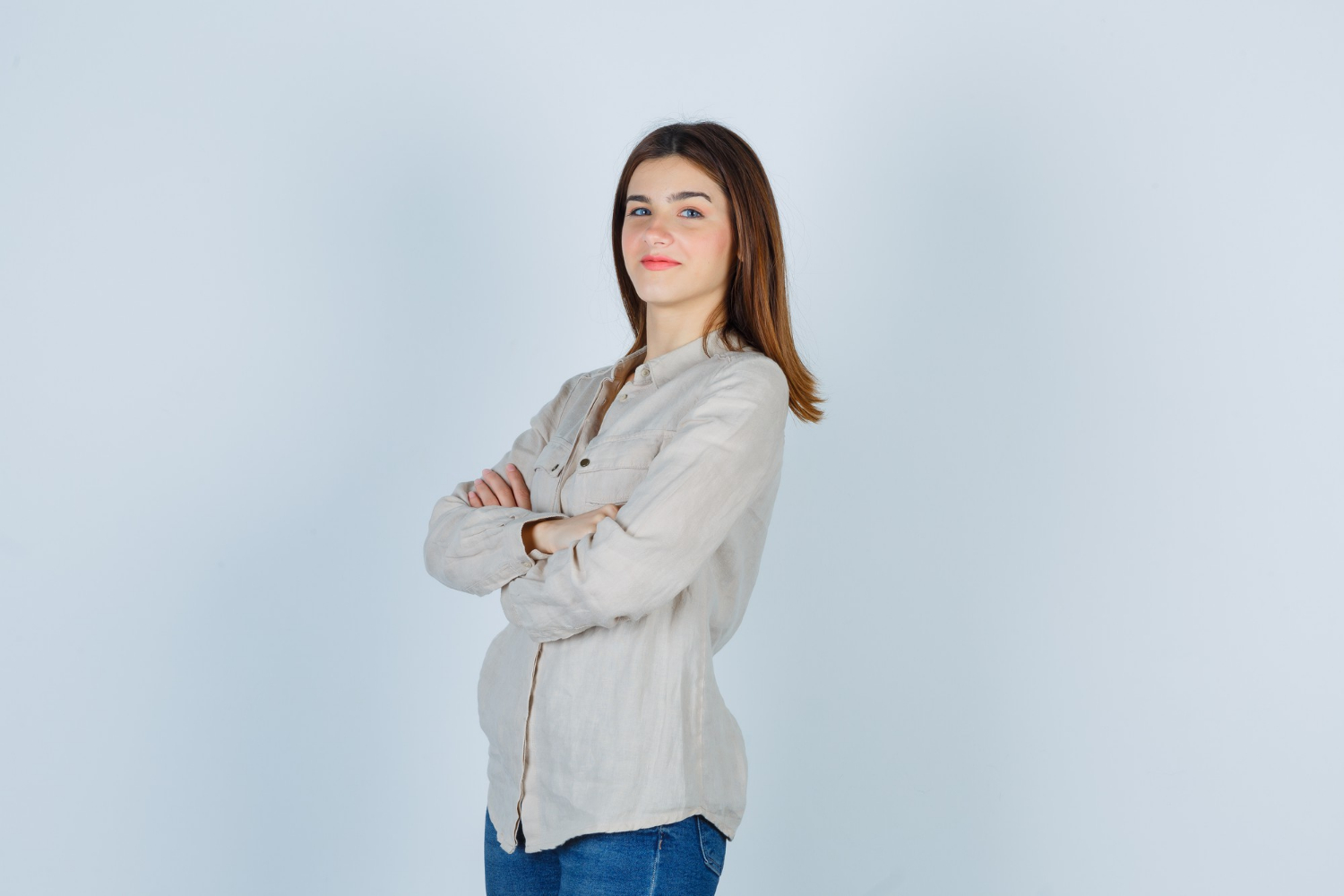 A smiling woman with her arms crossed | Source: Freepik