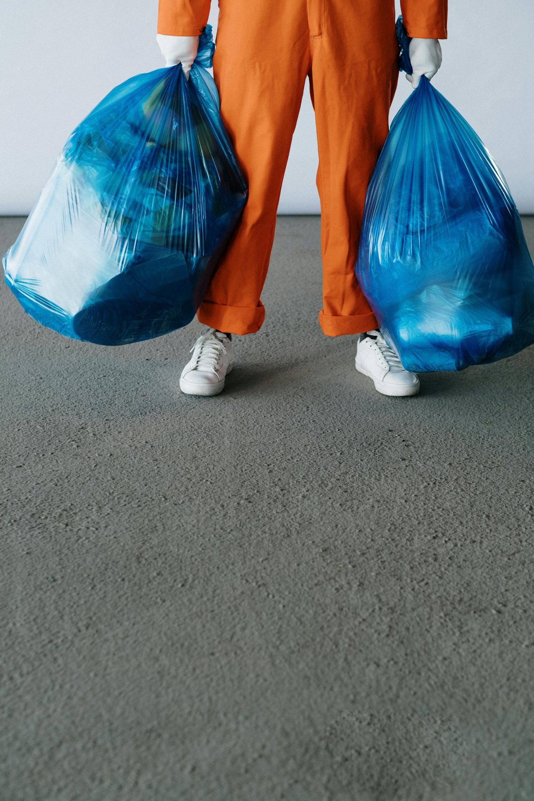 Close-up shot of a janitor holding garbage bags | Source: Pexels