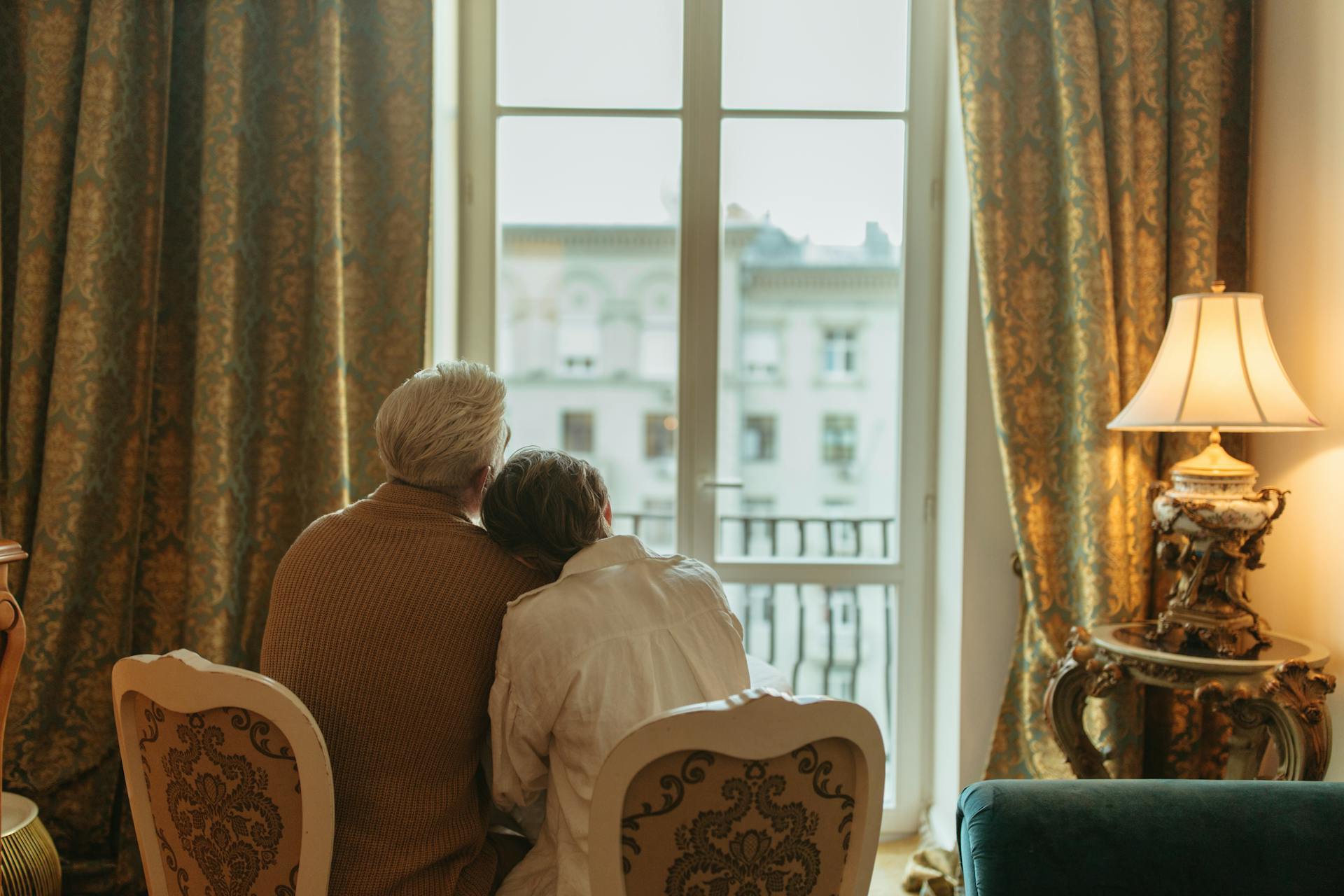A senior couple looking outside the window | Source: Pexels