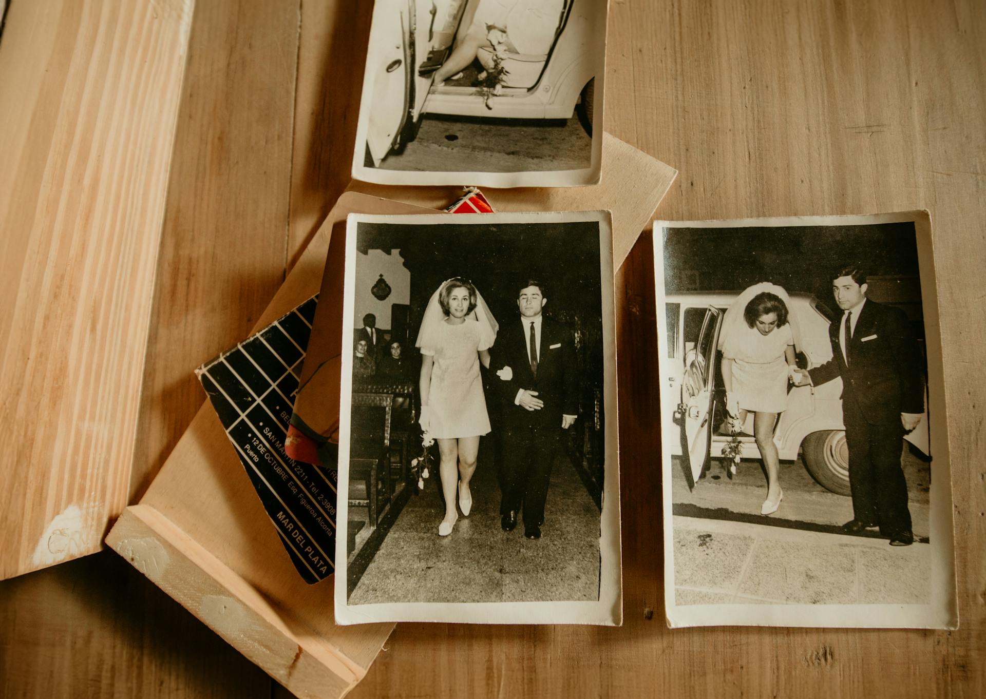 Vintage wedding photographs on a wooden surface | Source: Pexels