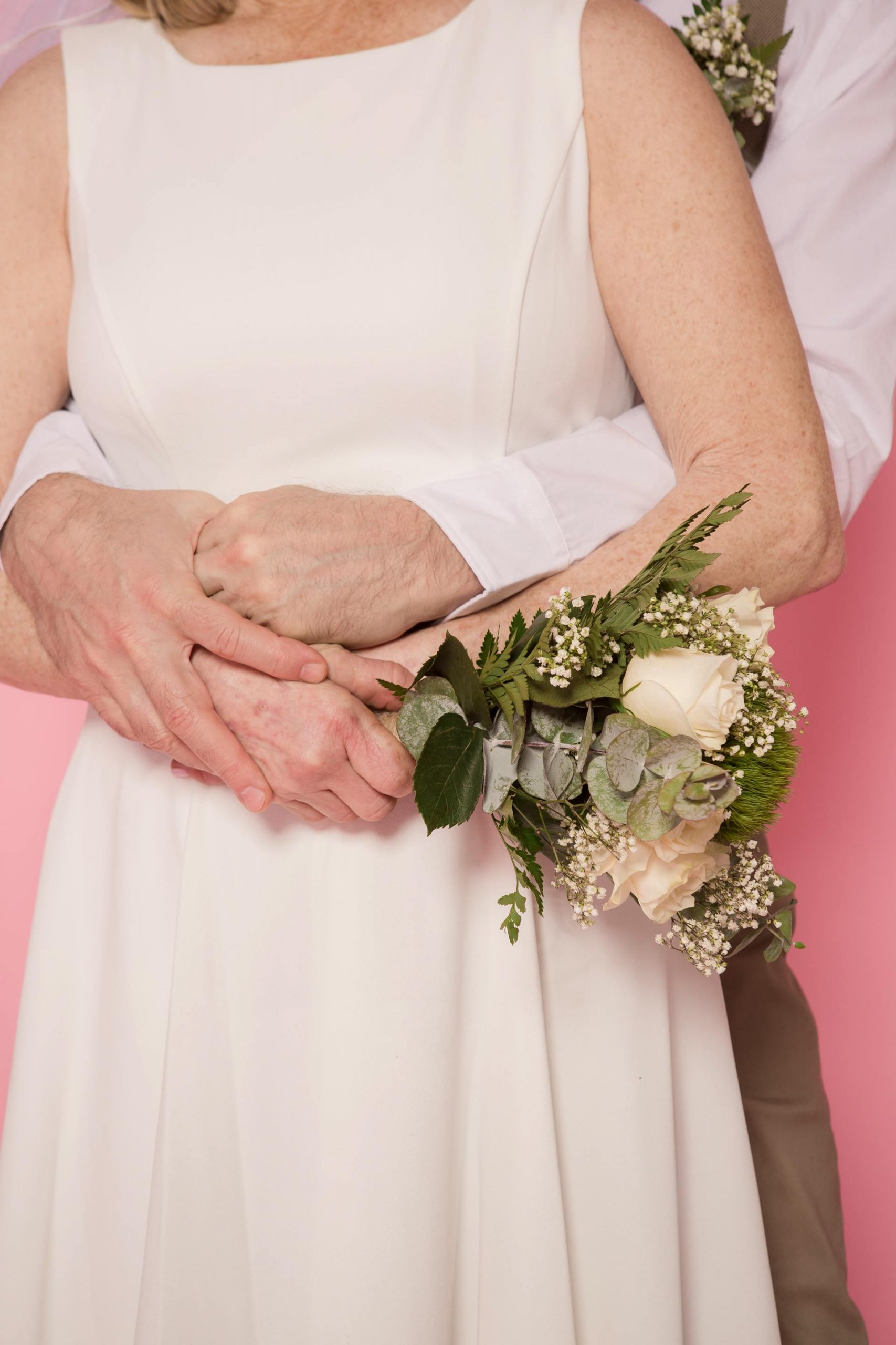 A close-up shot of a groom hugging his bride from behind | Source: Pexels