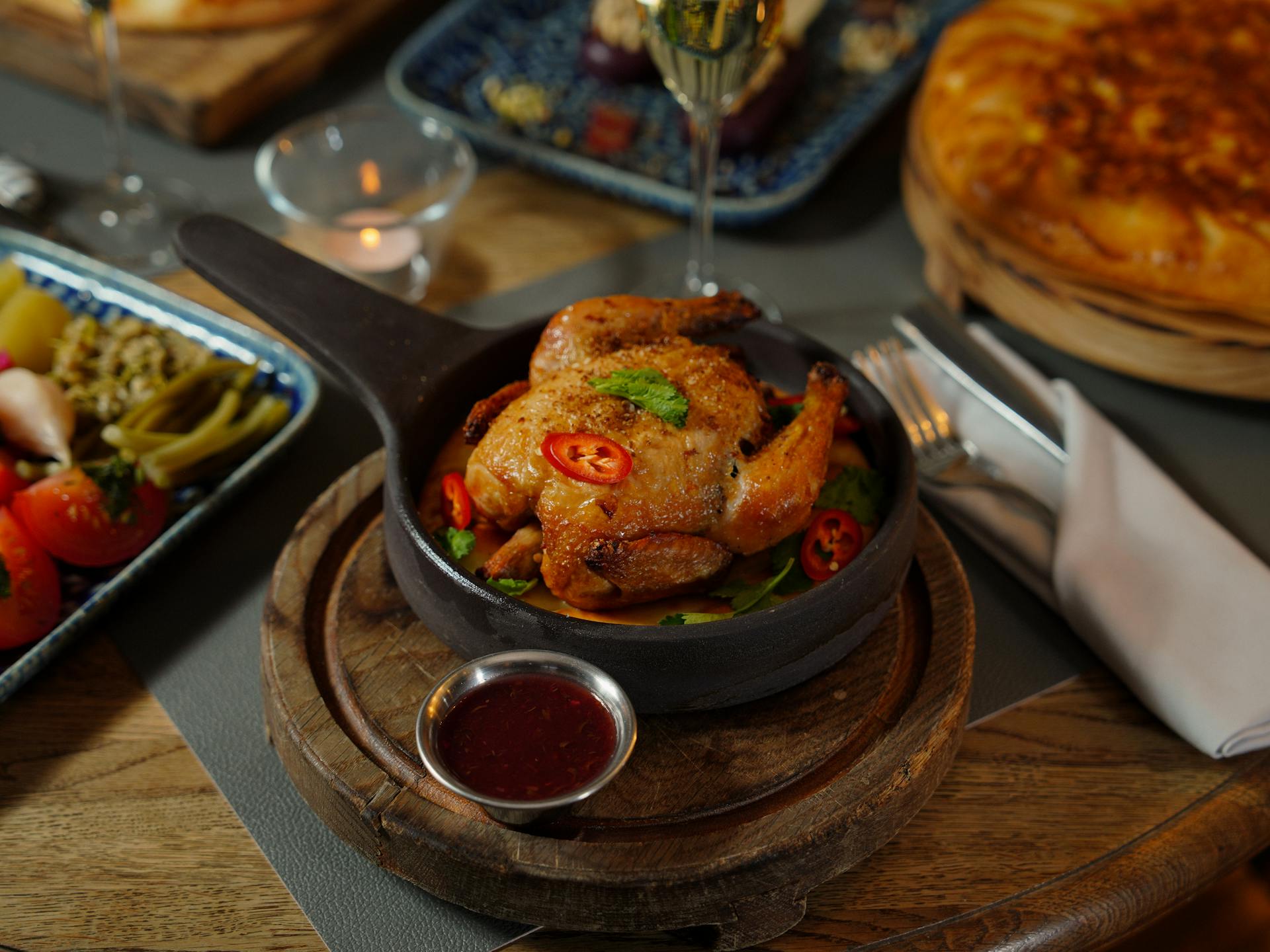 Roasted chicken with sauce served on the table | Source: Pexels
