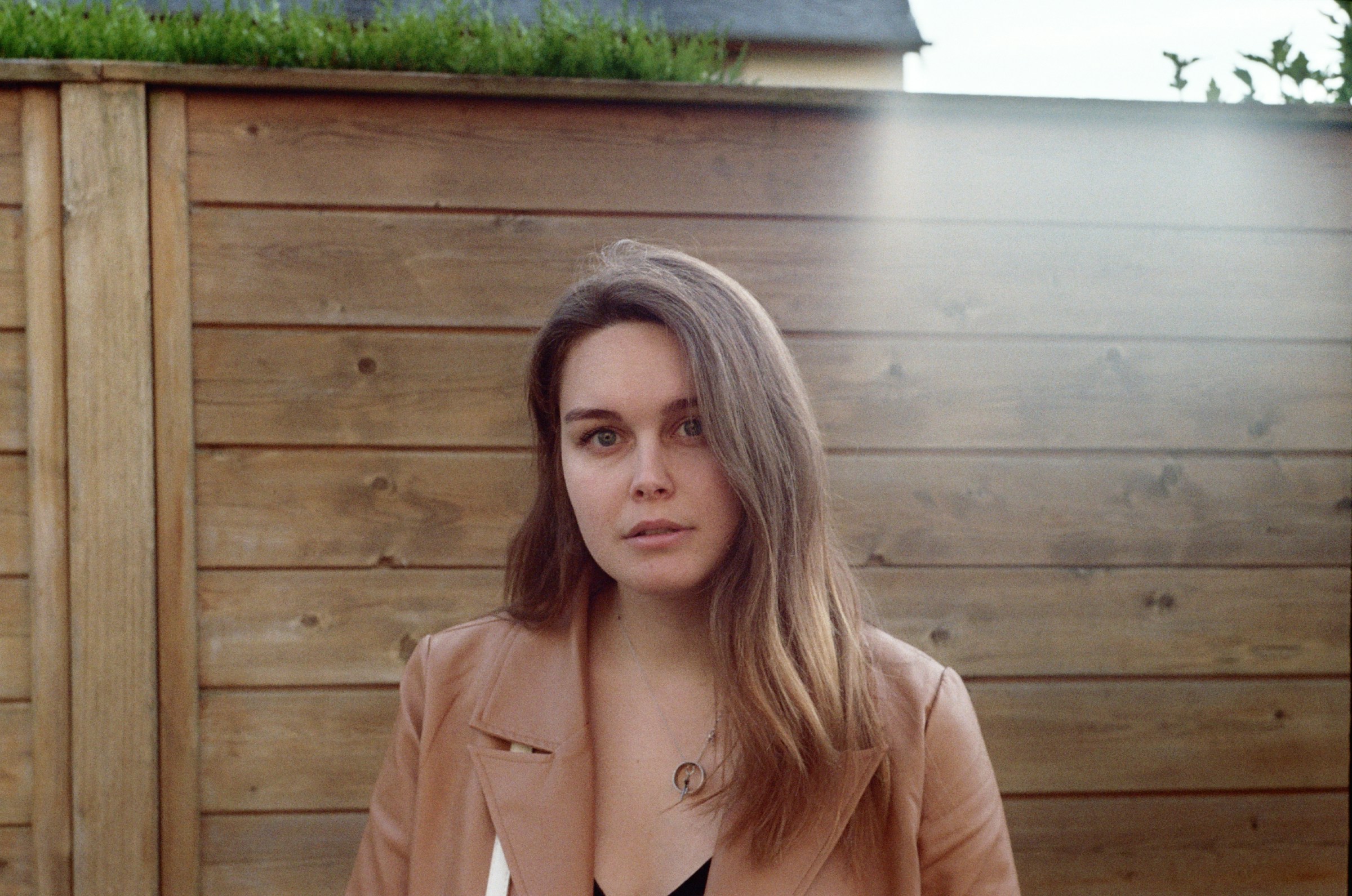 A surprised woman in a brown coat | Source: Unsplash