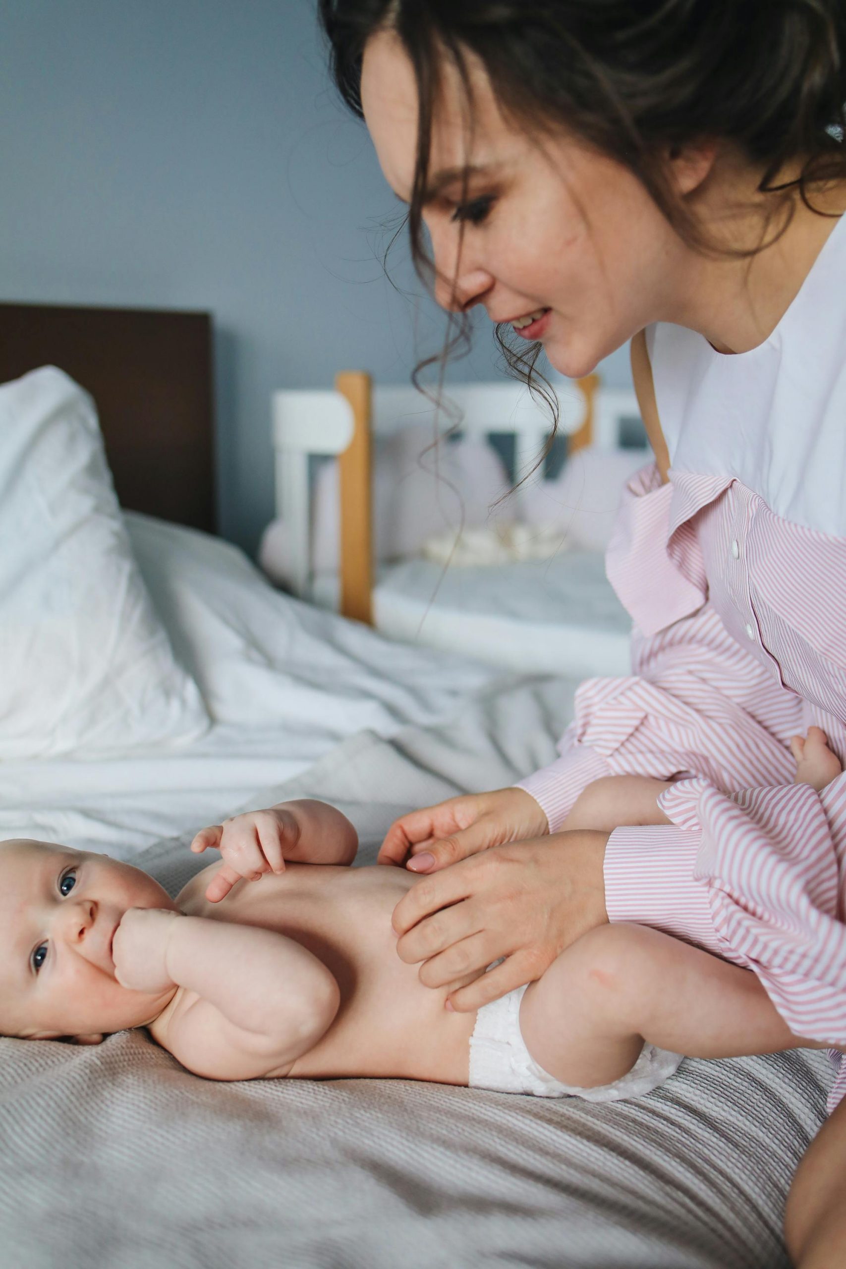 A woman attending to a baby | Source: Pexels