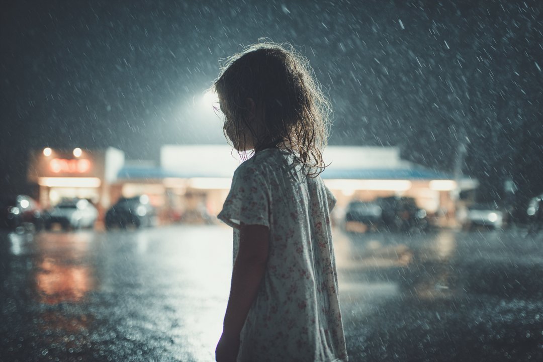 A little girl standing in the rain | Source: Midjourney