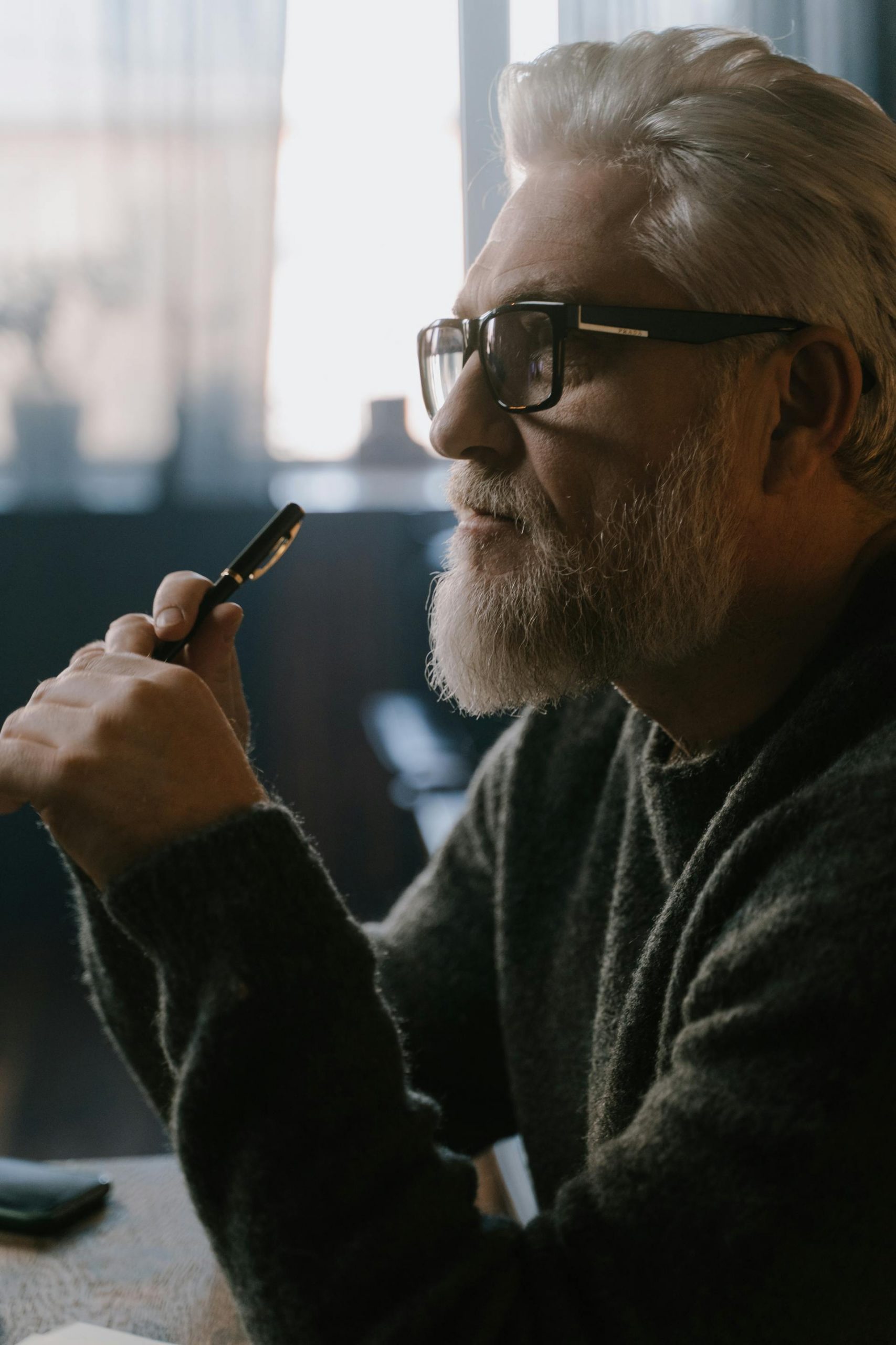 A thoughtful man holding a pen | Source: Pexels