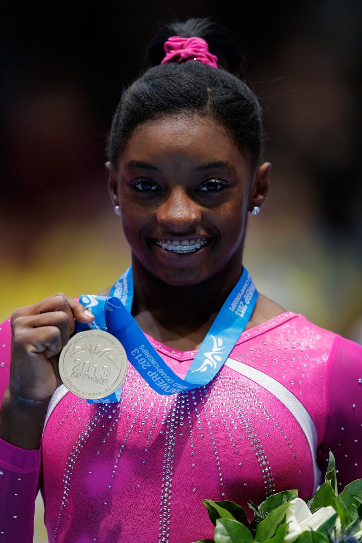 Simone Biles poses after winning the Women's All-Round Final on Day Five of the Artistic Gymnastics World Championships Belgium on October 4, 2013 | Source: Getty Images