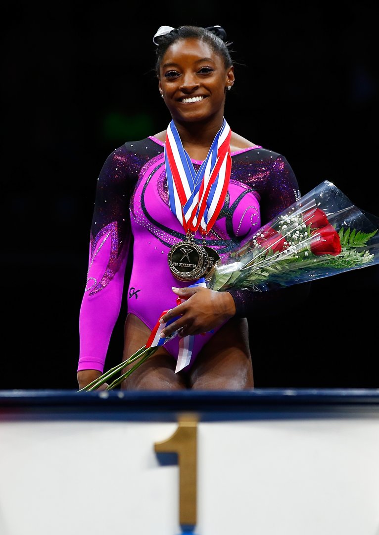 Simone Biles stands on the podium before accepting her gold medal in the senior women finals during the P&G Gymnastics Championships on August 23, 2014 | Source: Getty Images