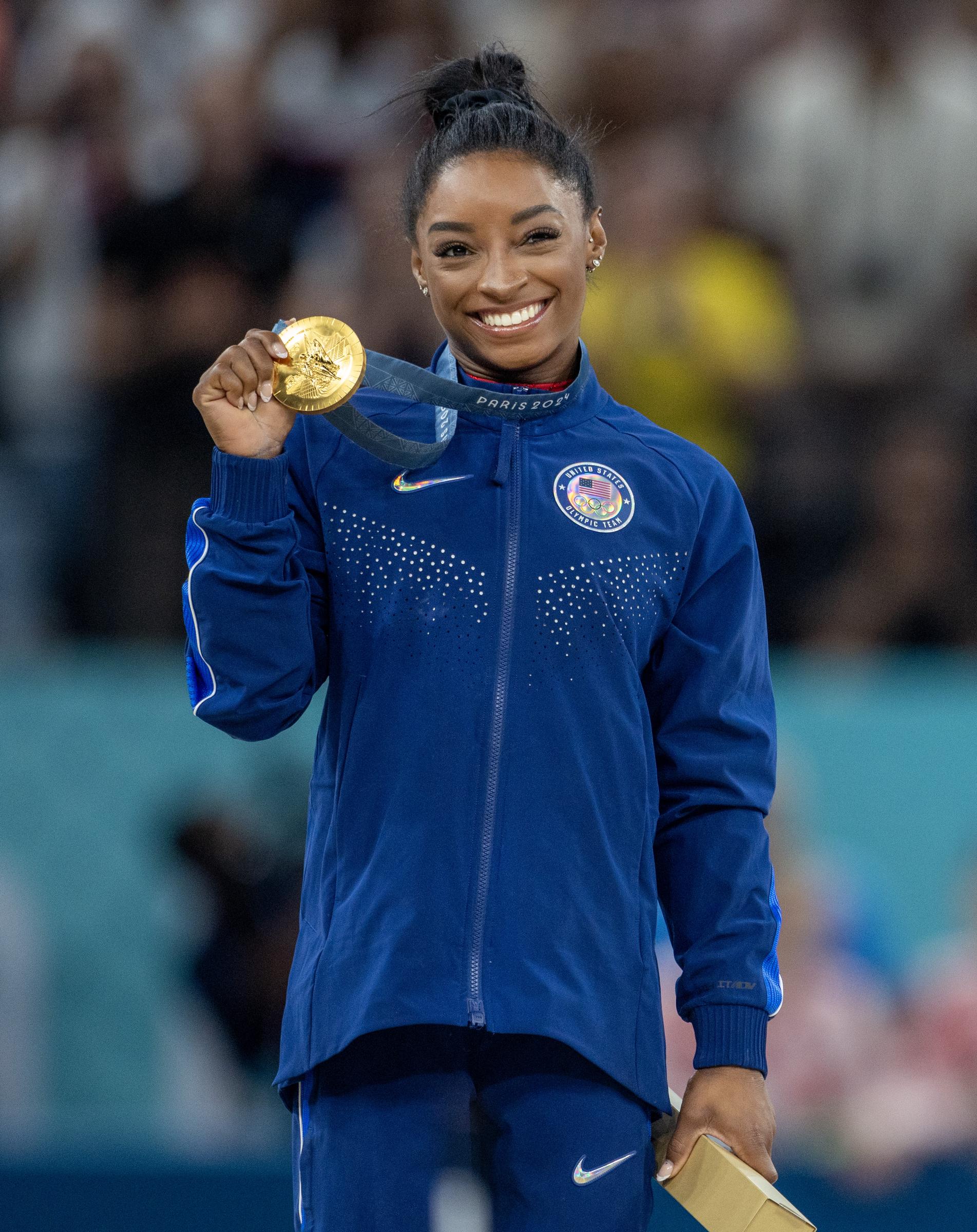 Simone Biles celebrates with her gold medal on the podium after her victory on the vault apparatus during Artistic Gymnastics, Women's Vault Final on August 3, 2024 | Source: Getty Images