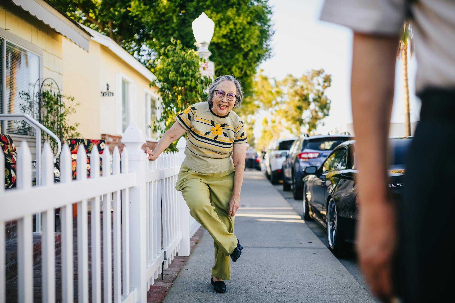 An older woman standing in a neighborhood | Source: Pexels