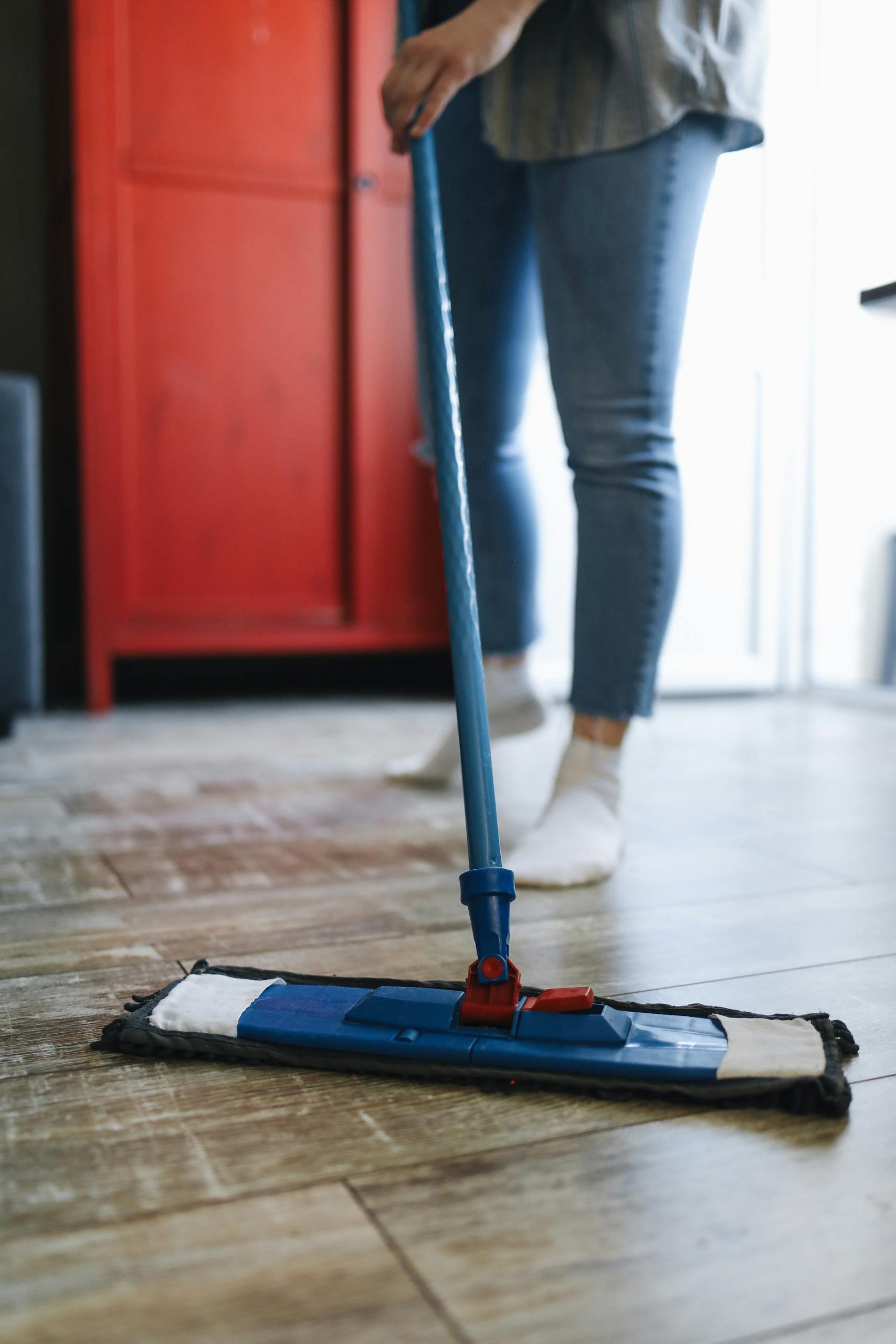A close-up shot of a person cleaning the floor with a mop | Source: Pexels