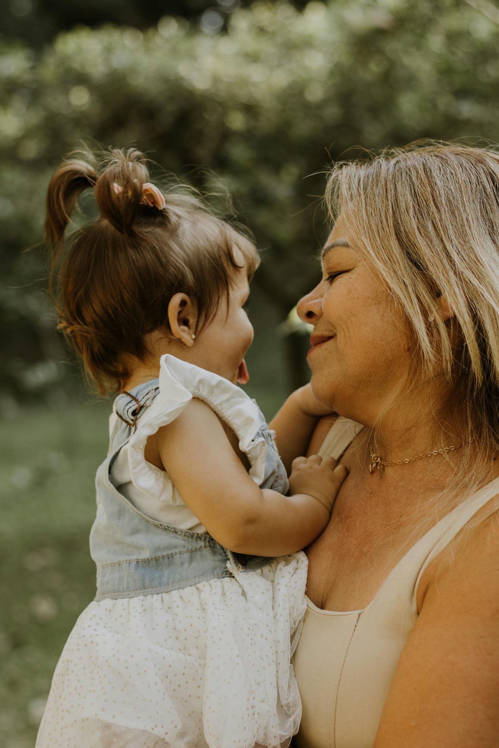 A loving grandmother holding a baby girl | Source: Pexels
