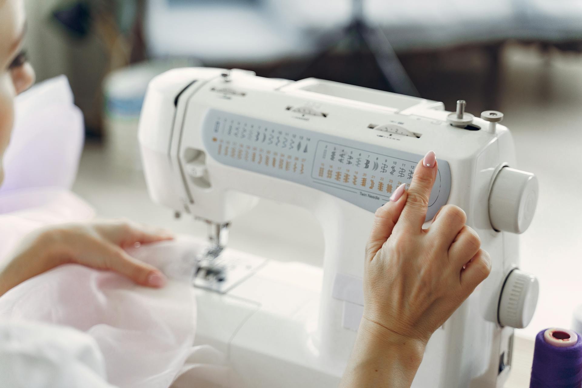 A woman using a sewing machine | Source: Pexels