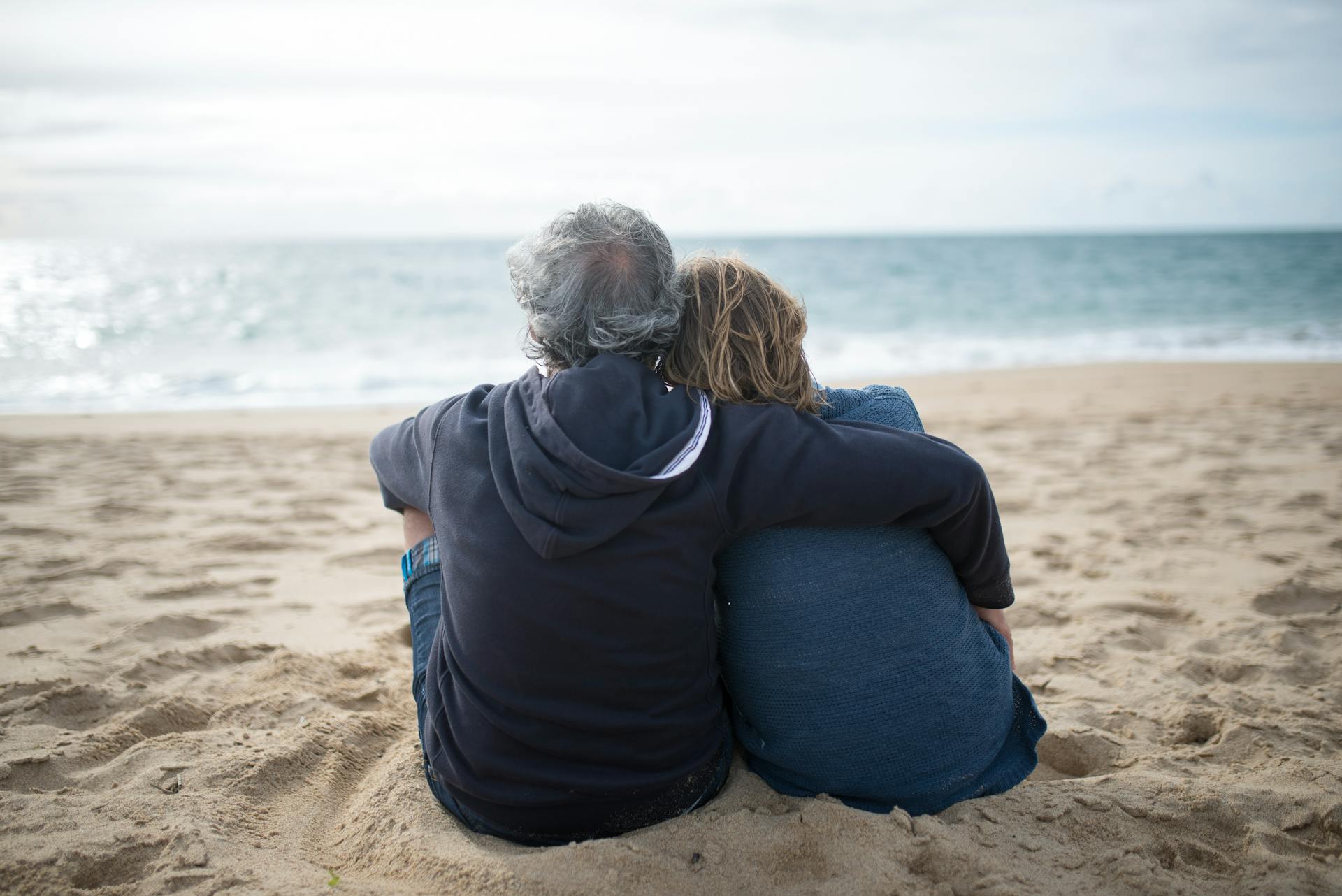 A senior couple sitting on the seashore | Source: Pexels