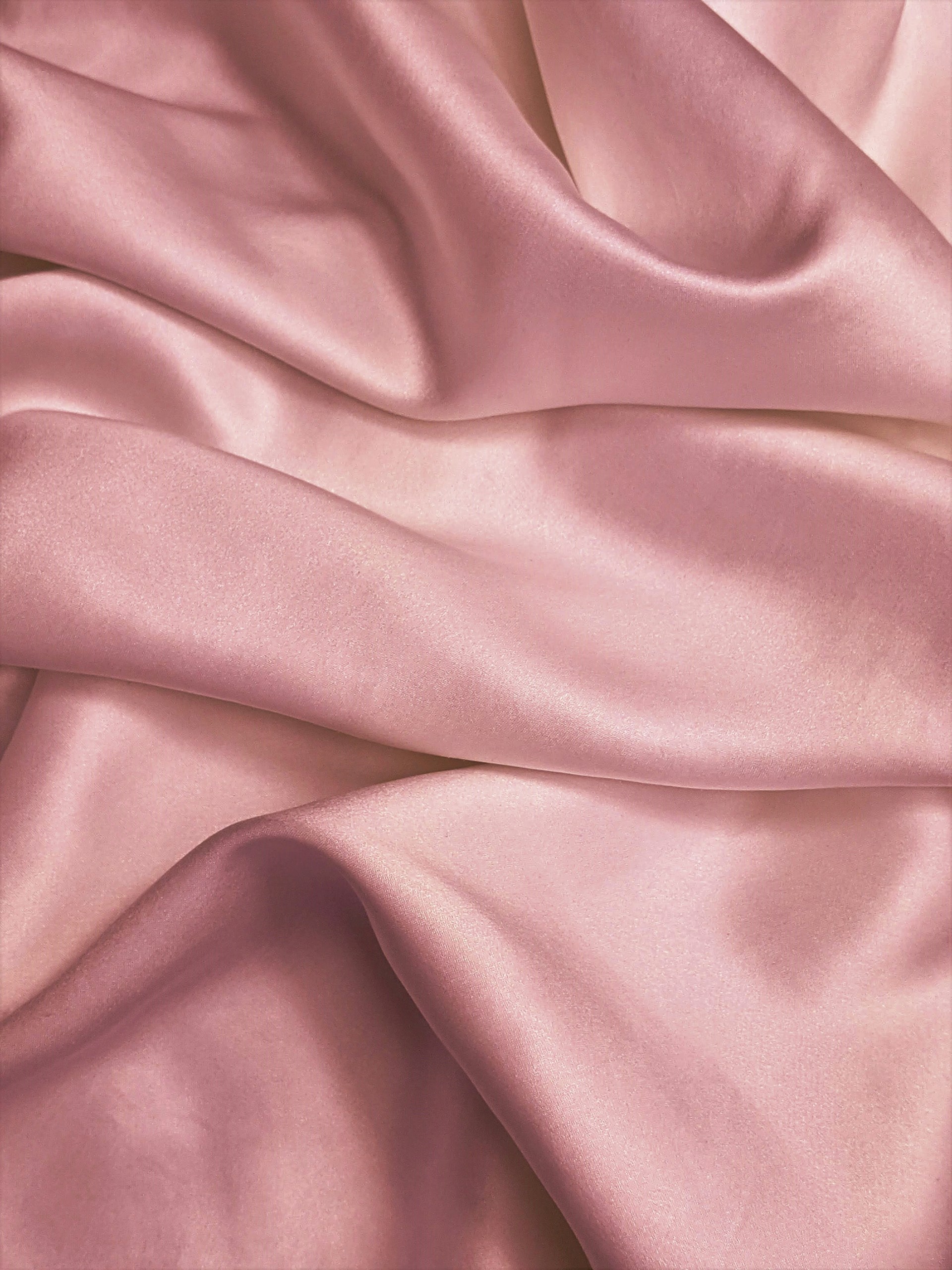 Close-up shot of a pink satin cloth | Source: Unsplash