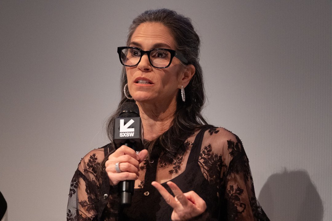 Speaking on stage at SXSW, Jami Gertz wore bold glasses and a black lace top, gesturing passionately as she addressed the audience.