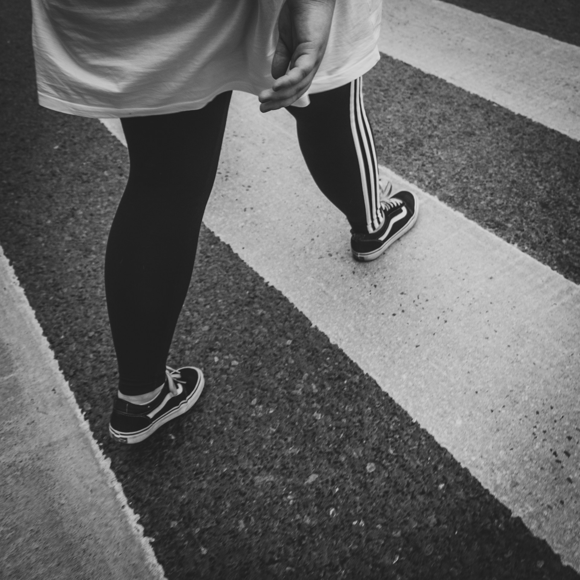 Grayscale shot of a person walking on the road | Source: Unsplash