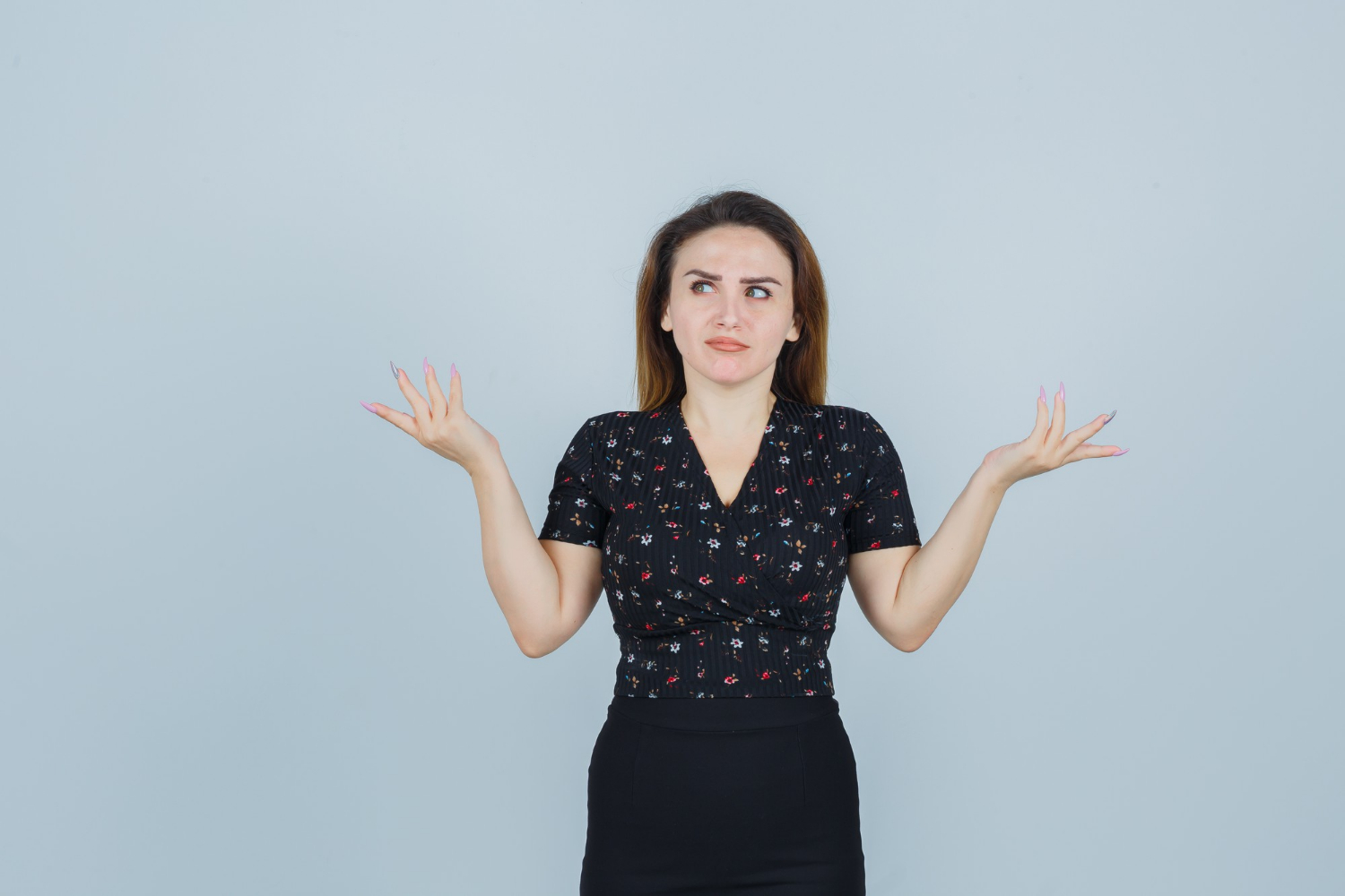 A woman shrugging | Source: Freepik