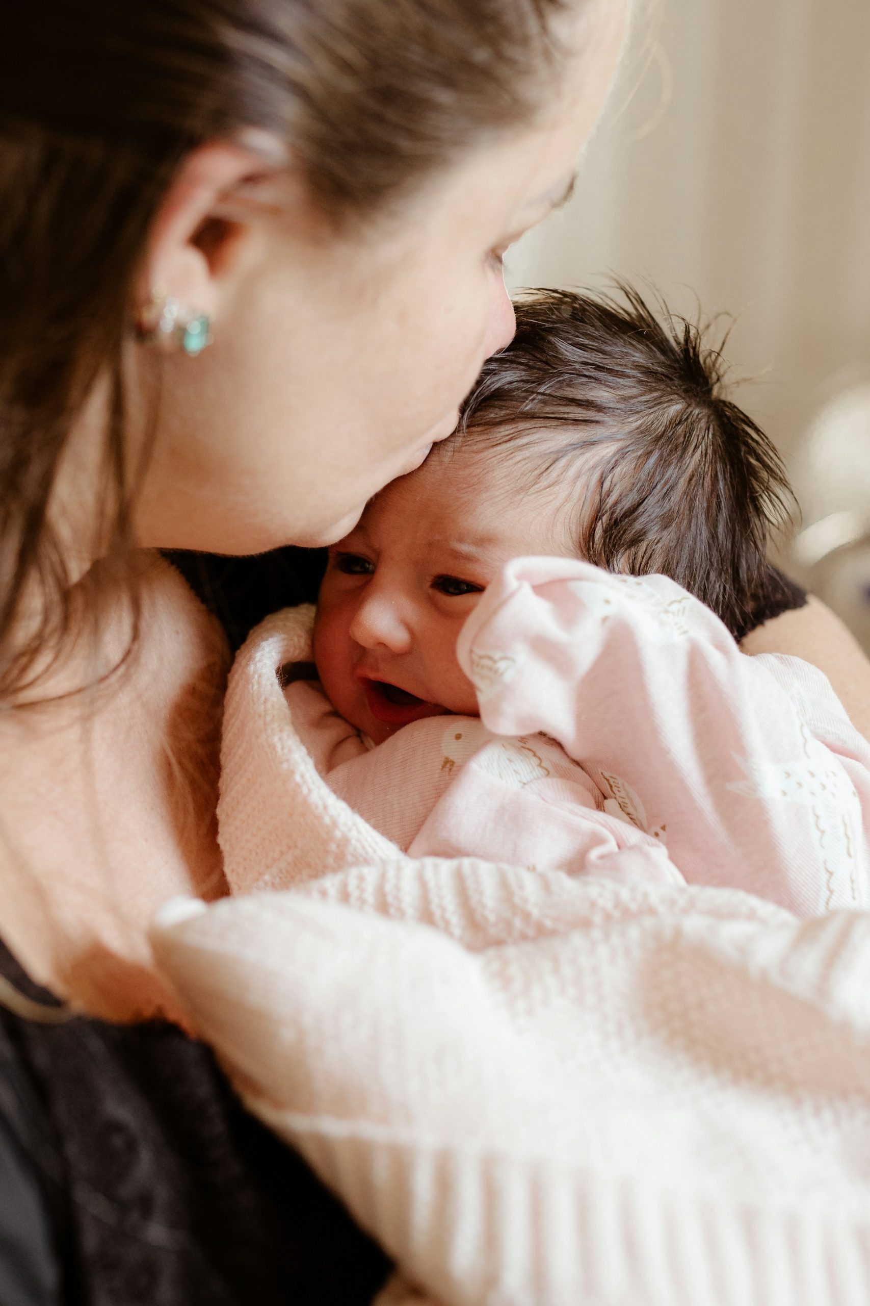 A mother kissing her baby | Source: Unsplash