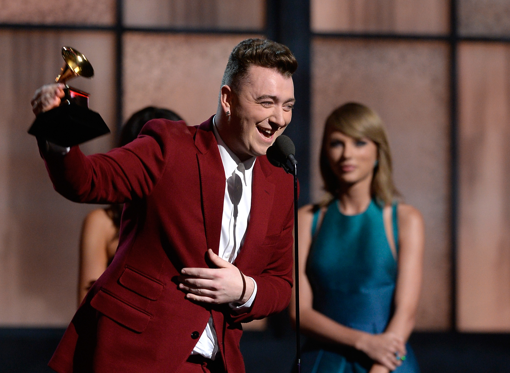 Sam Smith accepts the Best New Artist award from singer Taylor Swift onstage during the 57th Annual GRAMMY Awards on February 8, 2015 | Source: Getty Images