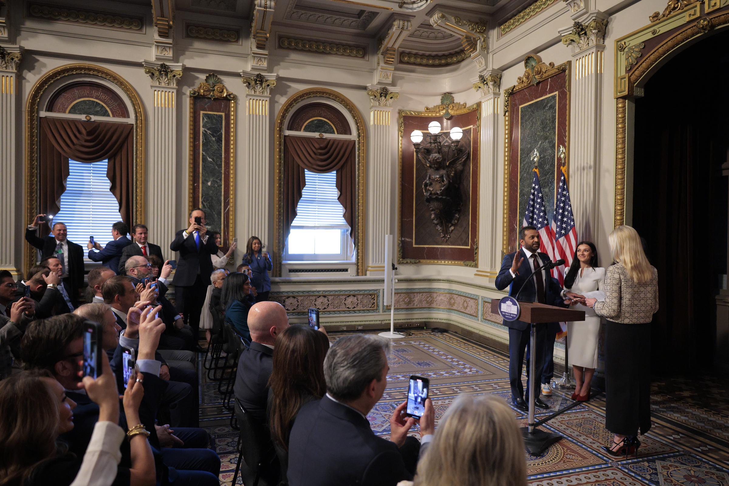 Attorney General Pam Bondi swears in the new Federal Bureau of Investigation Director Kash Patel as his girlfriend Alexis Wilkins holds the Bhagavad Gita in the Indian Treaty Room in the Eisenhower Executive Office Building on February 21, 2025, in Washington, DC | Source: Getty Images