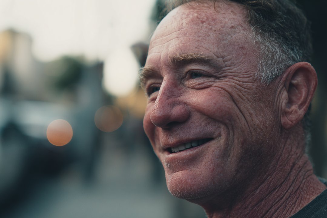 A man standing in a neighborhood | Source: Midjourney