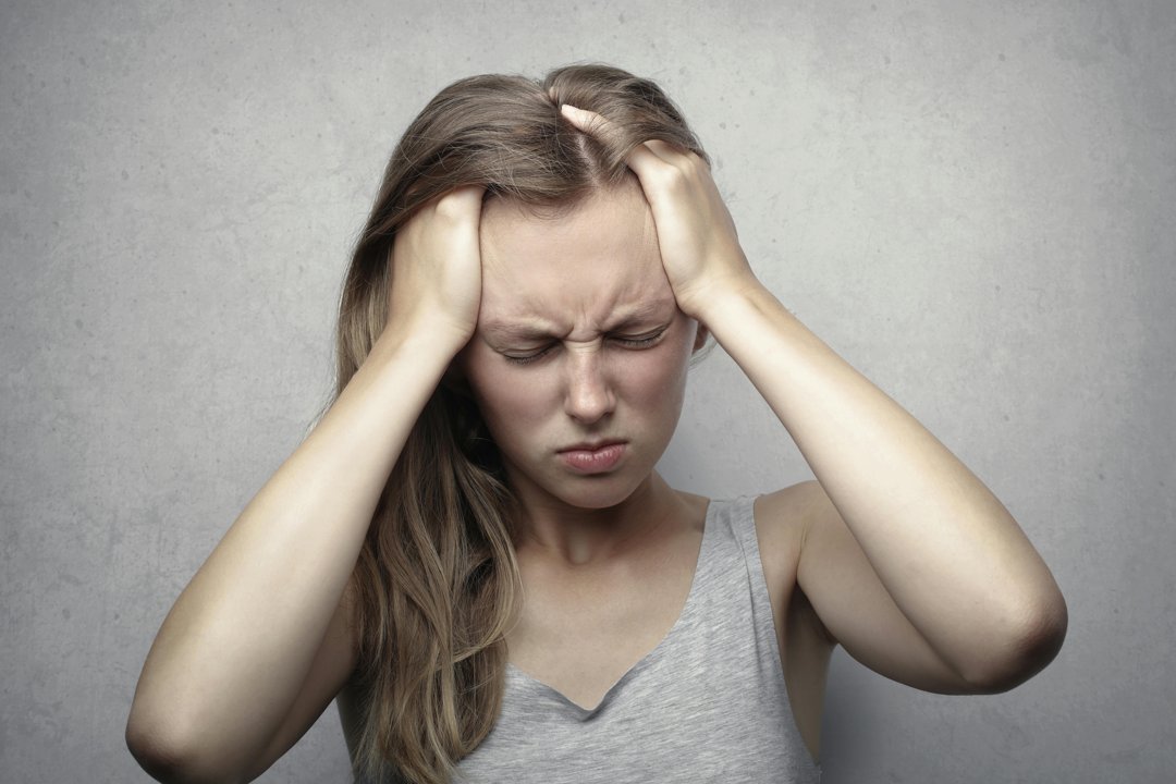 A frustrated woman with her hands on her head | Source: Pexels