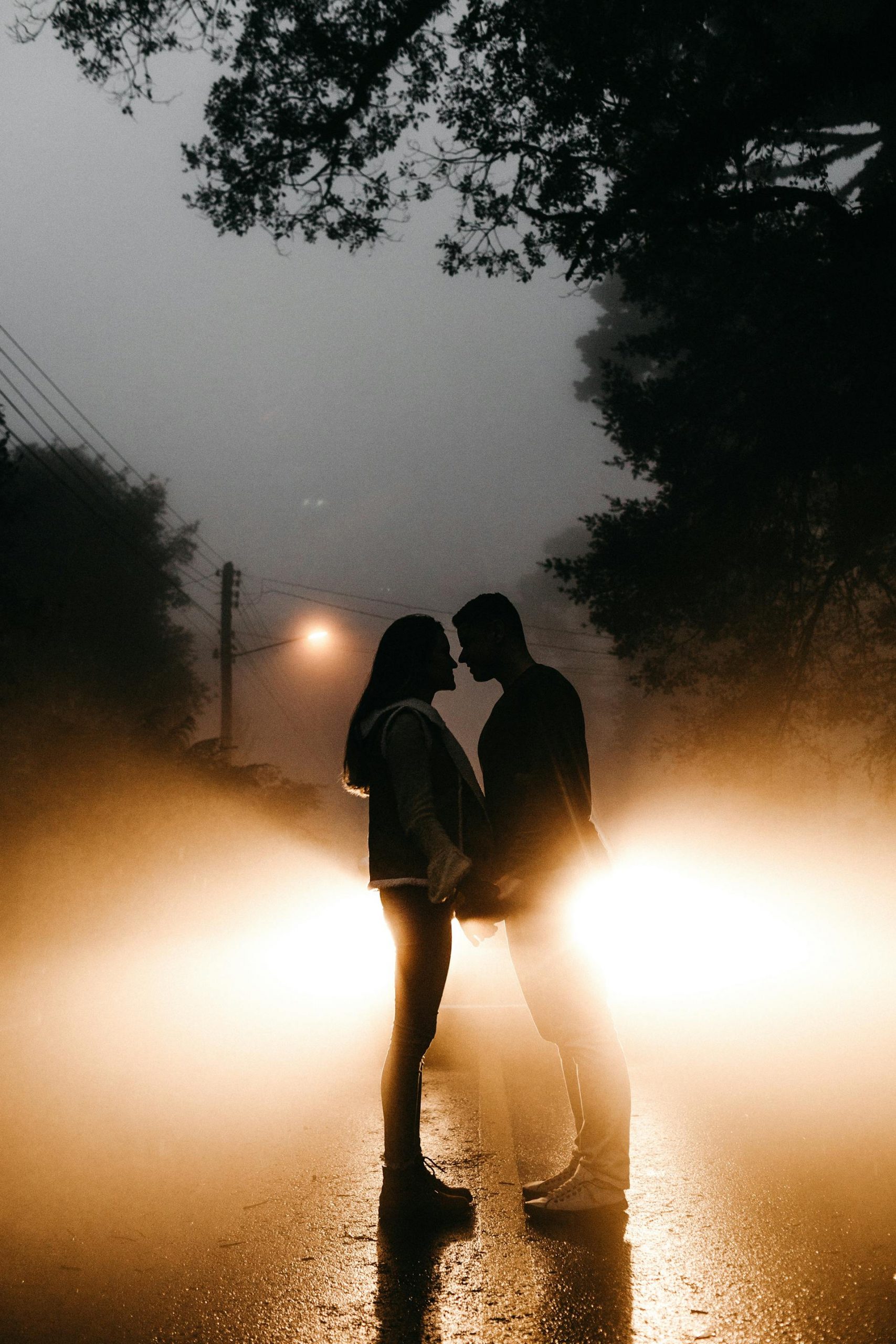 A couple standing on the road at night | Source: Pexels