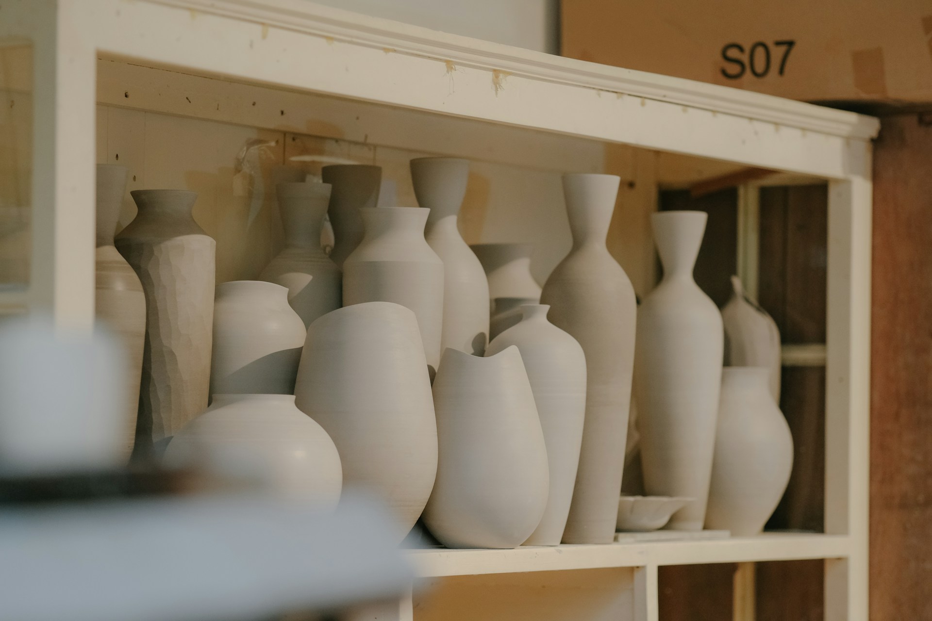 A pottery collection on a shelf | Source: Unsplash